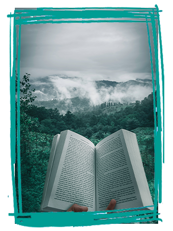 Reading in the outdoors, tress and mountains in the background.