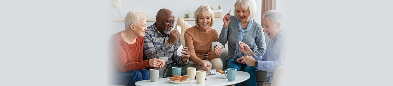 Group of people socialising and playing cards