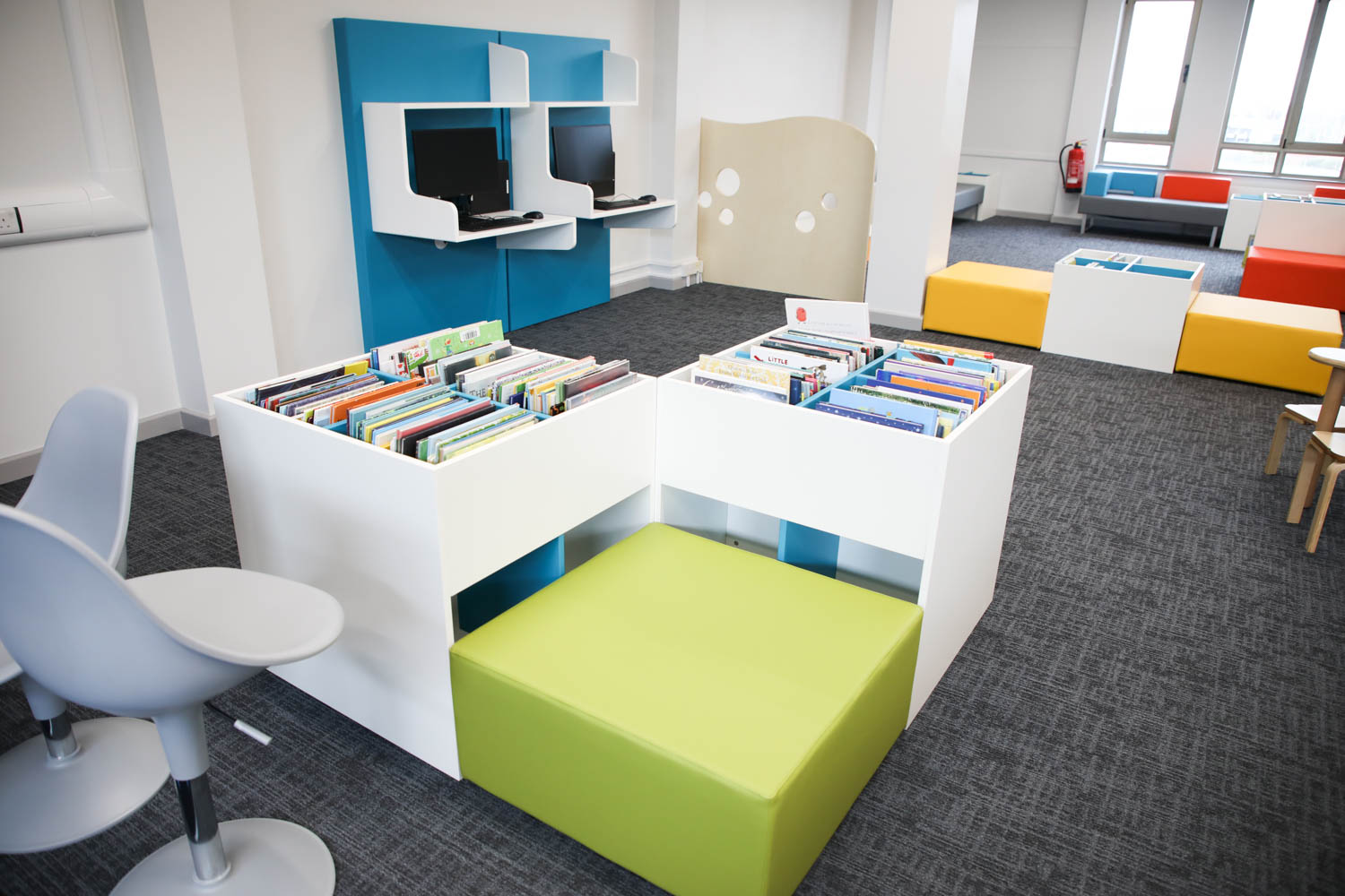 Books in a library and comfortable seating area