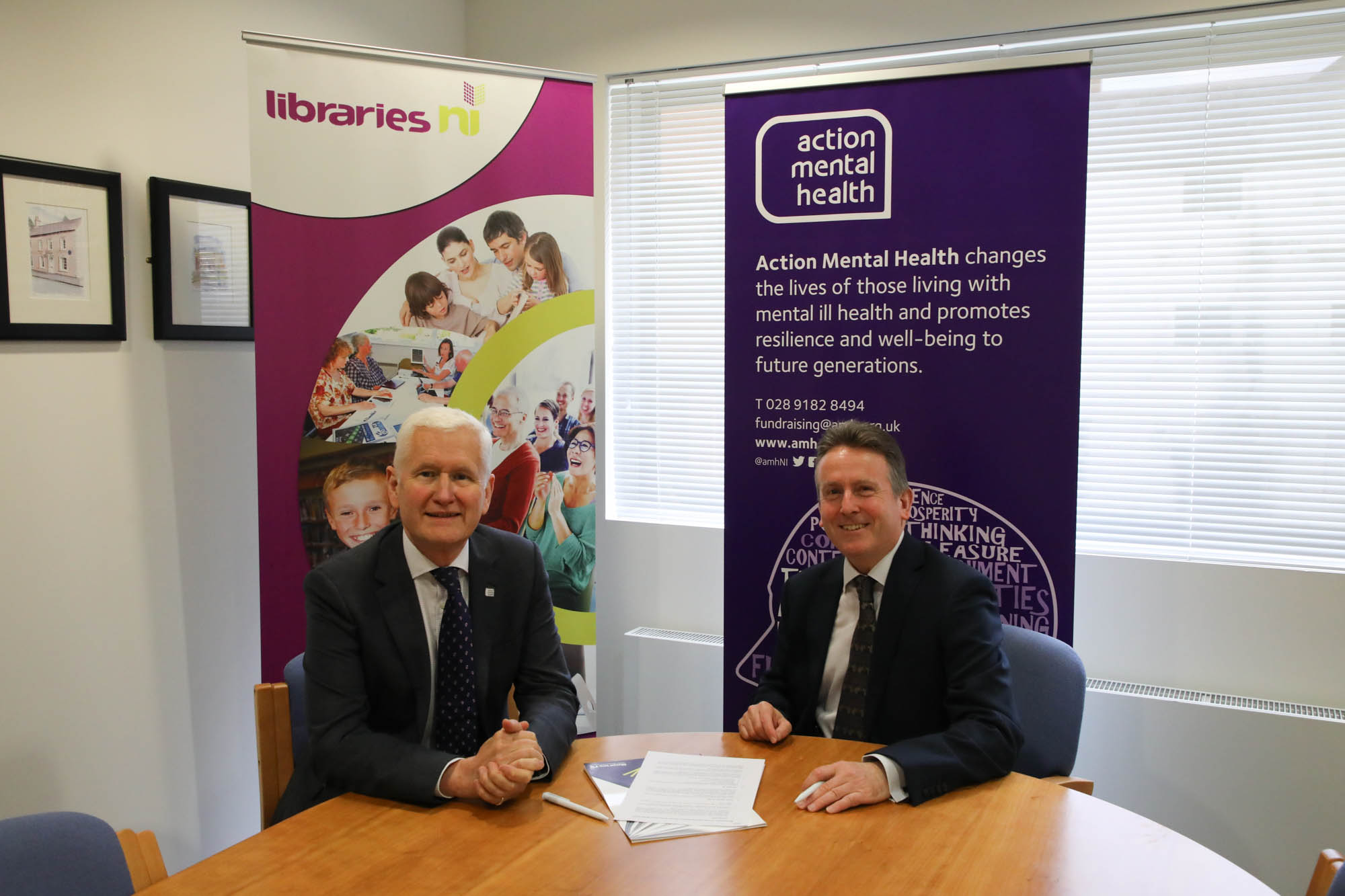Jim O’Hagan, Chief Executive of Libraries NI and David Babington Chief Executive from Action Mental Health signing a memorandum of understanding