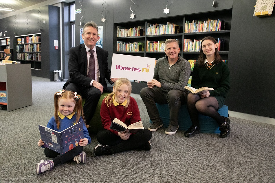 Libraries NI Chief Executive, Jim O’Hagan,  is pictured with Chris Quinn, NI Children's Commissioner,  and pupils from Coláiste Feirste , Bunscoil An tSléibhe Dhuibh and St Maria Goretti Nursery School at the official opening of the newly renovated children’s library at Whiterock Library.
