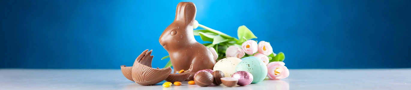 A picture of a chocolate bunny and chocolate Easter eggs