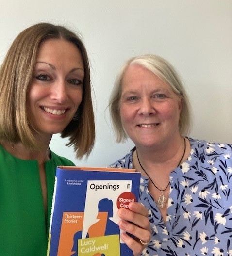 A photo of author Lucy Caldwell holding a copy of her book called Openings alongside our Jillian
