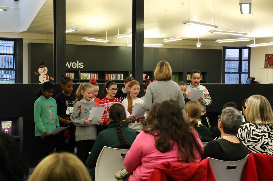 Pupils from Holy Trinity Primary School entertain guests with some festive songs at the official launch of the newly renovated children’s library.