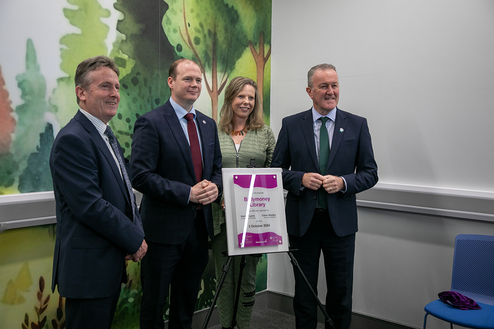 Photo of Dr. Jim O’Hagan, Libraries NI Chief Executive, Communities Minister Gordon Lyons, Ms. Bonnie Anley, Chair of Libraries NI and Economy Minister Conor Murphy with Causeway Coast and Glens Mayor Cllr Ciarán McQuillan.