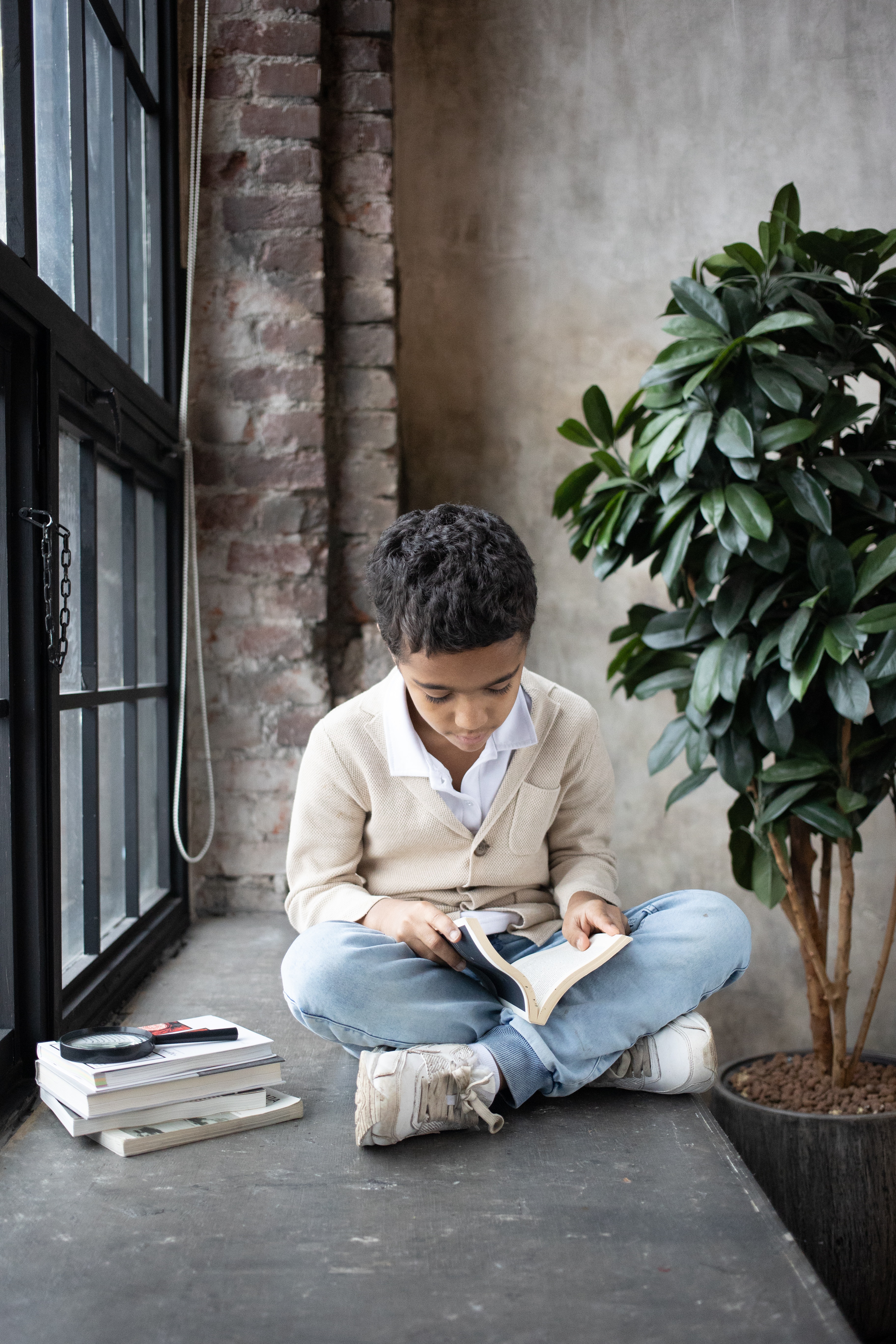 Boy sitting reading a book