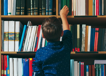 a child browsing books at the library