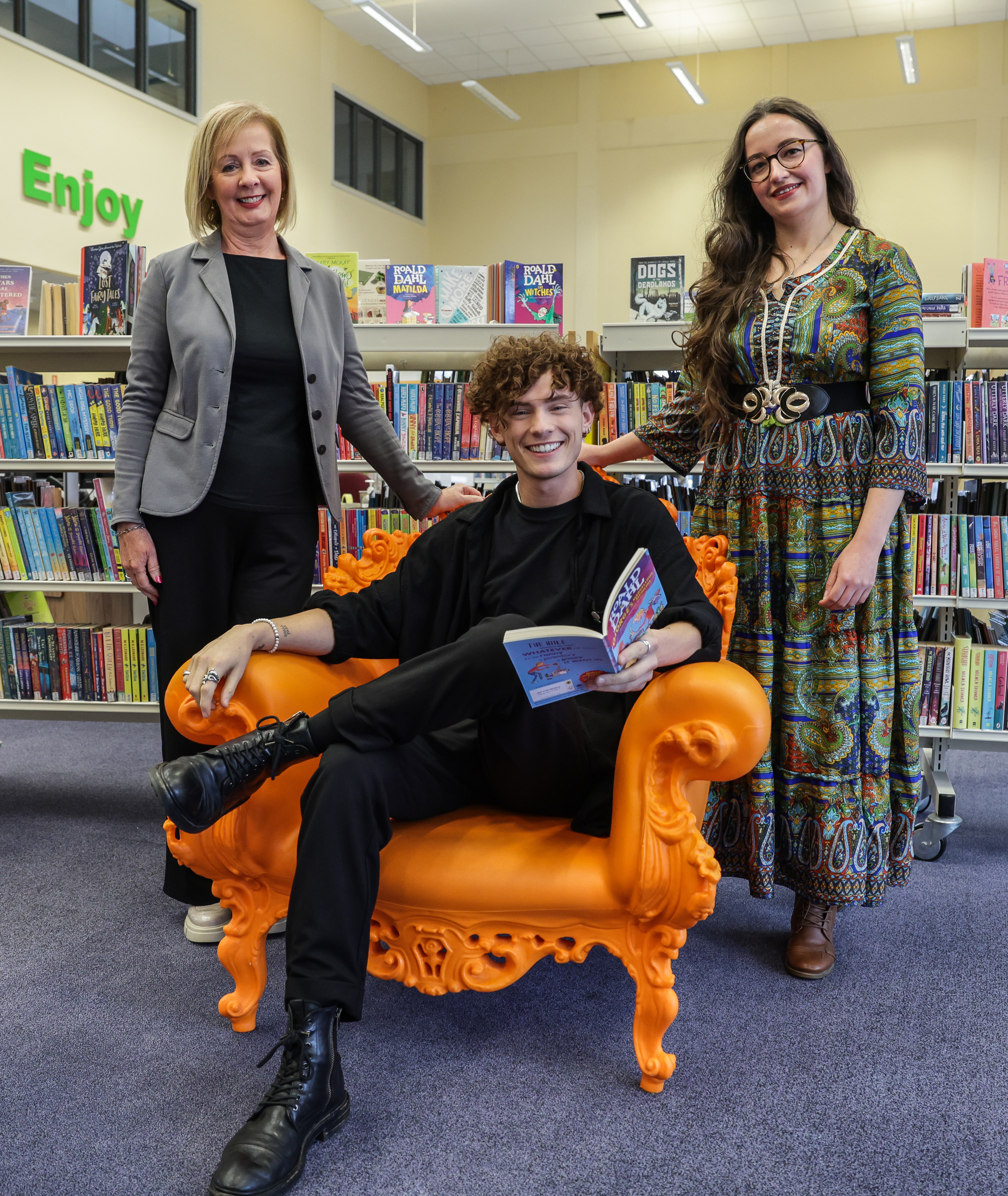 Blue Peter presenter Joel M is pictured with Libraries NI Area Manager Bernie McCann (left) and Cookstown Library Branch Manager Kendra Reynolds (Right)