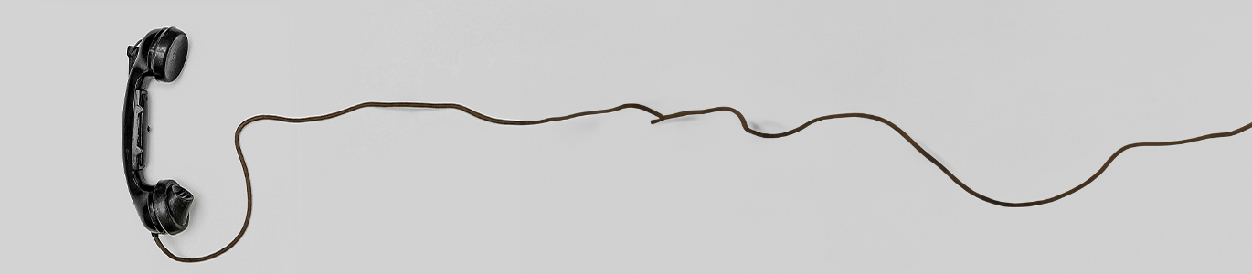 A photo of an old telephone and cord