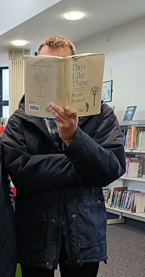 Brian Bilston holding his book, Days Like These