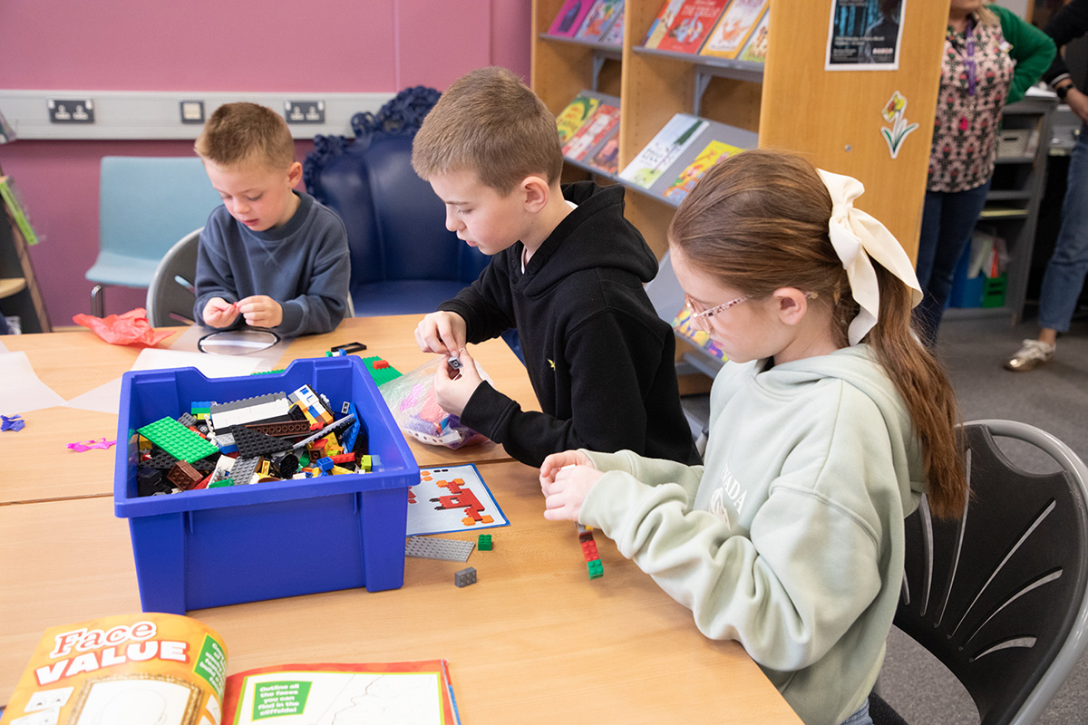 children taking part in an arts and crafts session in a library