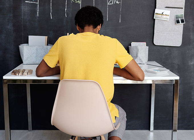 Teenager sitting at a desk revising